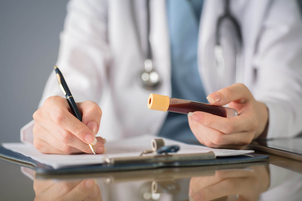 close up of internal medicine doctor writing 